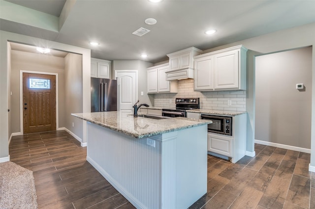 kitchen featuring stainless steel appliances, dark wood-style flooring, and white cabinetry
