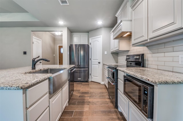 kitchen with white cabinetry, dark wood-type flooring, backsplash, visible vents, and black appliances