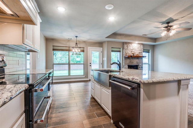 kitchen featuring decorative backsplash, recessed lighting, white cabinetry, a sink, and stainless steel appliances