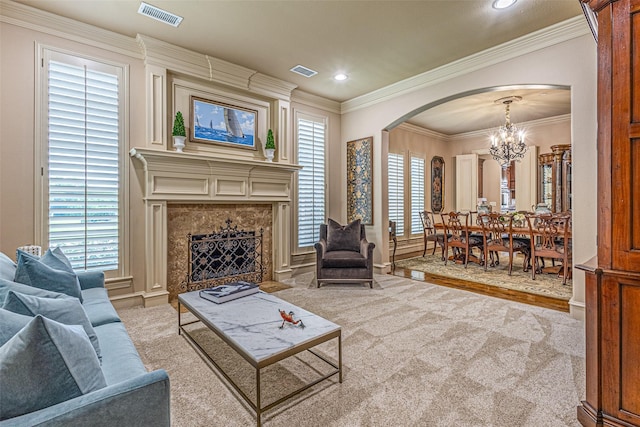 4230 Indian Creek Ln, Frisco, TX 75033 - carpeted living area with arched walkways, a chandelier, crown molding, a high end fireplace, and recessed lighting