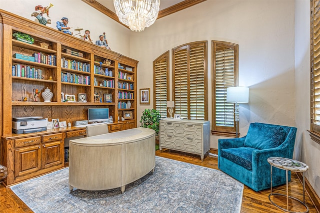 4230 Indian Creek Ln, Frisco, TX 75033 - office space featuring built in desk, an inviting chandelier, wood finished floors, crown molding, and baseboards