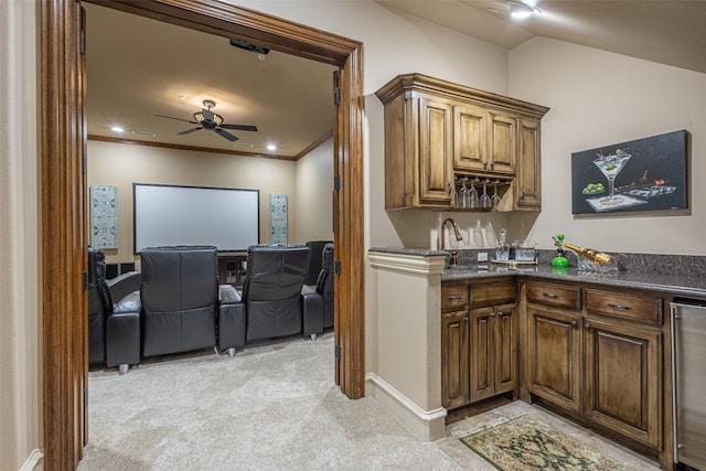 kitchen featuring ceiling fan, light colored carpet, a sink, wine cooler, and ornamental molding