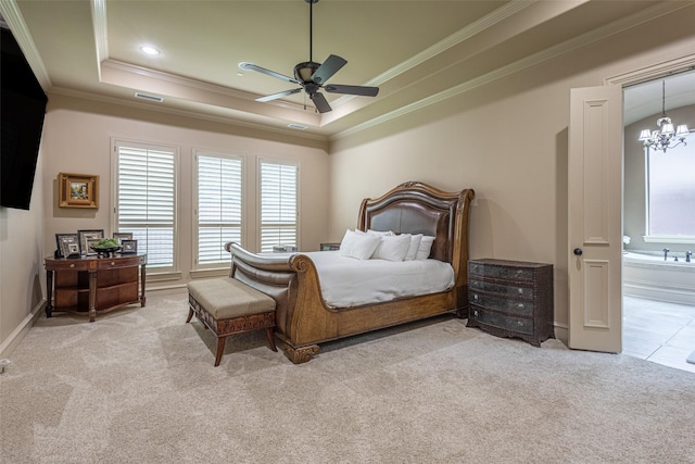 carpeted bedroom with ensuite bath, baseboards, a tray ceiling, visible vents, and ornamental molding
