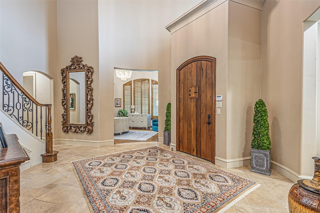 4230 Indian Creek Ln, Frisco, TX 75033 - entrance foyer with baseboards, a towering ceiling, stone finish floor, and arched walkways