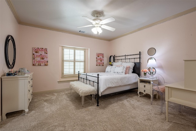 bedroom featuring ceiling fan, visible vents, crown molding, baseboards, and light carpet