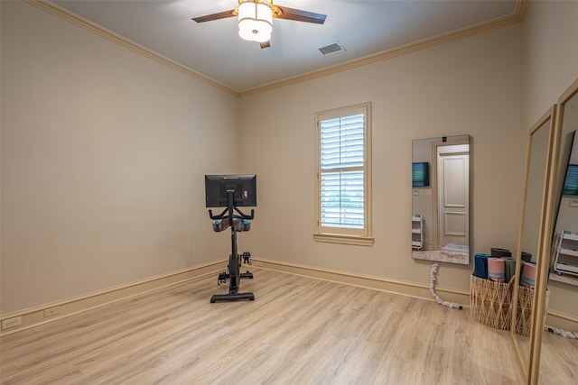 workout area featuring ceiling fan, visible vents, wood finished floors, baseboards, and ornamental molding