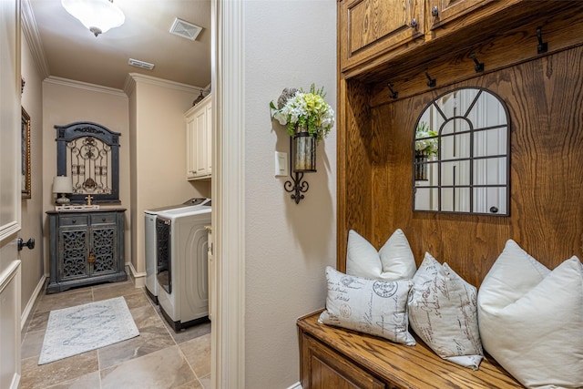 washroom featuring separate washer and dryer, ornamental molding, cabinet space, and visible vents
