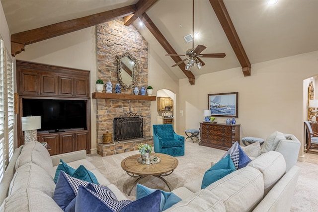 carpeted living area featuring visible vents, beam ceiling, a fireplace, high vaulted ceiling, and arched walkways