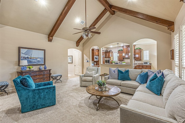 4230 Indian Creek Ln, Frisco, TX 75033 - living area with arched walkways, carpet floors, ceiling fan, baseboards, and beamed ceiling