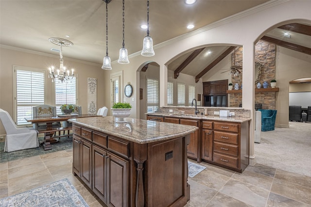kitchen featuring a sink, arched walkways, a center island, and lofted ceiling with beams