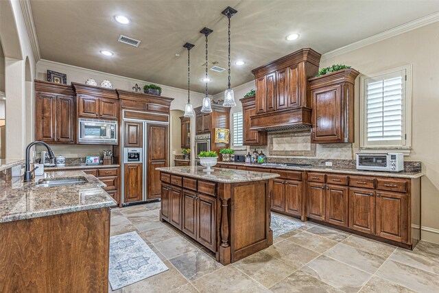4230 Indian Creek Ln, Frisco, TX 75033 - kitchen featuring a sink, built in appliances, light stone countertops, healthy amount of natural light, and crown molding
