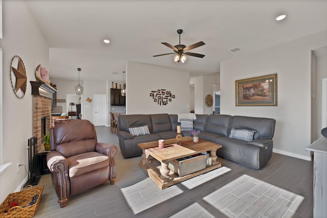 living area featuring wood tiled floor, ceiling fan, visible vents, baseboards, and recessed lighting