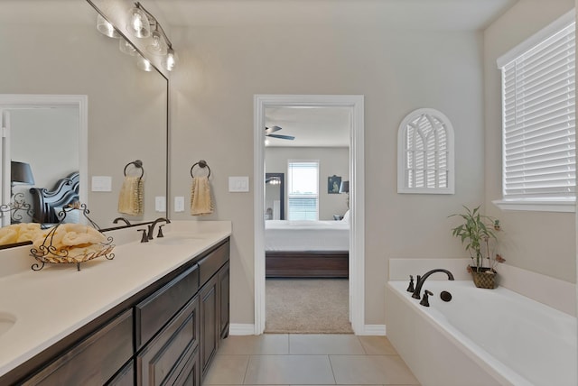 full bath featuring a garden tub, double vanity, ensuite bathroom, tile patterned floors, and a sink
