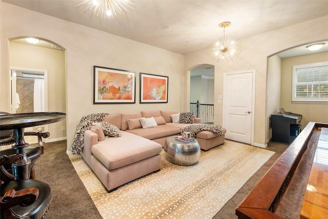 1005 Mallard Lakes Dr, Mckinney, TX 75072 - carpeted living area with arched walkways, a chandelier, and baseboards