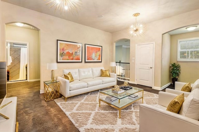 1005 Mallard Lakes Dr, Mckinney, TX 75072 - living room featuring arched walkways, baseboards, and a chandelier