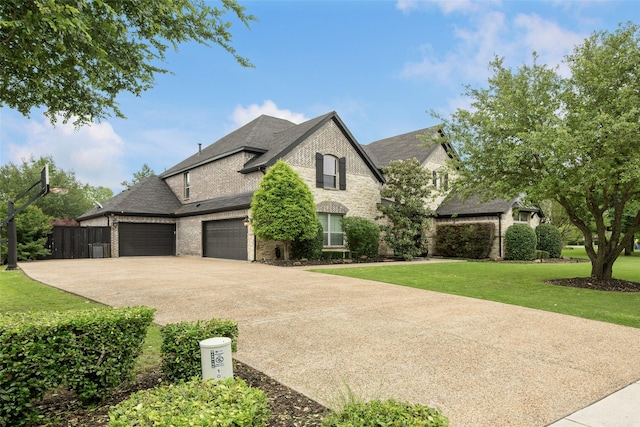1005 Mallard Lakes Dr, Mckinney, TX 75072 - french country inspired facade with concrete driveway, a garage, brick siding, and stone siding