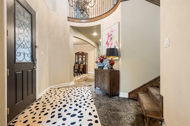 1005 Mallard Lakes Dr, Mckinney, TX 75072 - foyer entrance with arched walkways, baseboards, a towering ceiling, a chandelier, and stairway