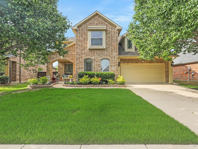 2420 Forest Gate Dr, Little Elm, TX 75068 - traditional-style home featuring concrete driveway, a front lawn, brick siding, and roof with shingles