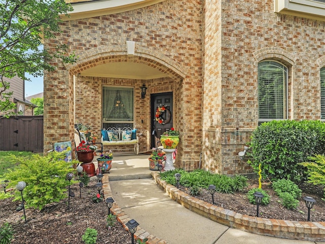 2420 Forest Gate Dr, Little Elm, TX 75068 - property entrance with brick siding, covered porch, and fence