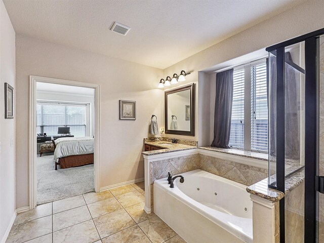 2420 Forest Gate Dr, Little Elm, TX 75068 - ensuite bathroom featuring a jetted tub, baseboards, a sink, and tile patterned flooring