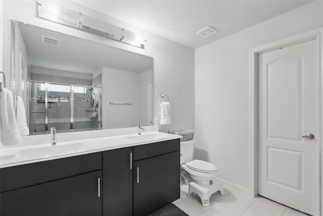 1036 Fairfax Dr, Godley, TX 76044 - full bath featuring double vanity, a shower stall, tile patterned flooring, toilet, and baseboards
