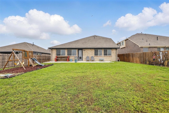 1036 Fairfax Dr, Godley, TX 76044 - back of house featuring a patio area, a playground, brick siding, and roof with shingles
