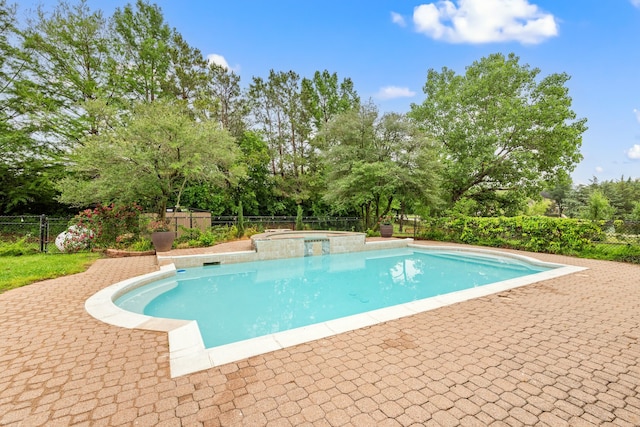 view of pool with a fenced backyard, a patio area, and a pool with connected hot tub