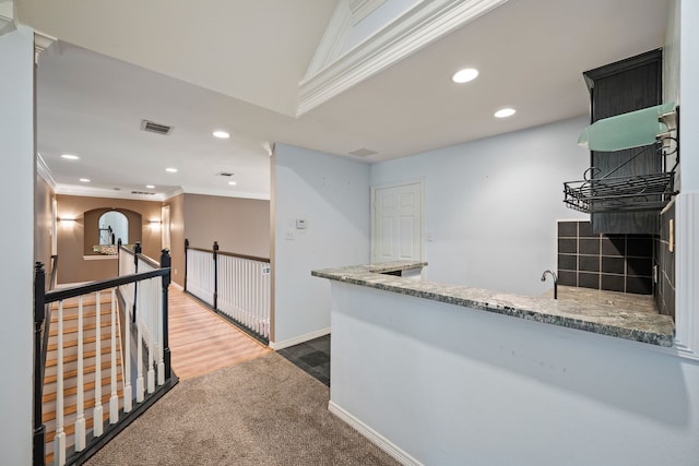 kitchen featuring crown molding, carpet floors, recessed lighting, and visible vents