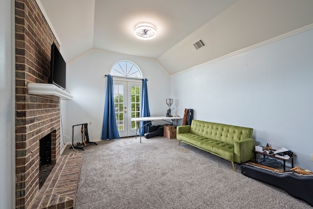 living area featuring carpet floors, a fireplace, vaulted ceiling, and visible vents