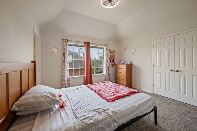carpeted bedroom with a closet and vaulted ceiling