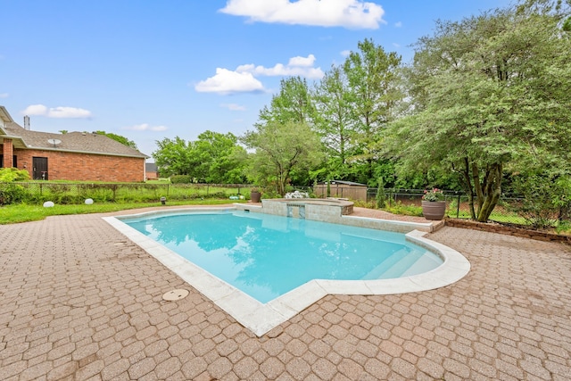 view of swimming pool featuring a fenced backyard, a patio area, and a pool with connected hot tub