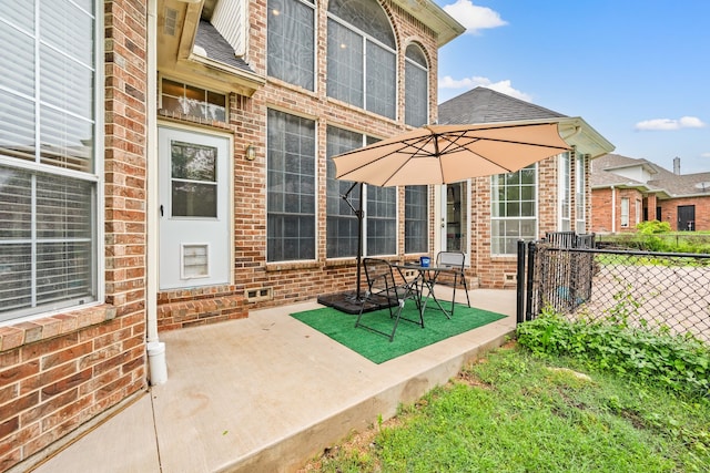 view of patio featuring fence