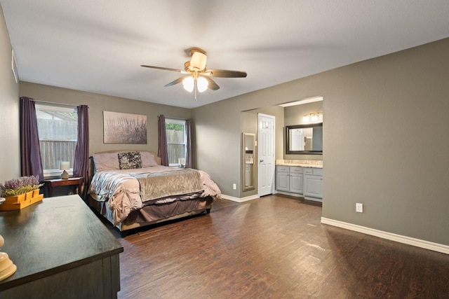 bedroom featuring baseboards, a ceiling fan, dark wood finished floors, and ensuite bathroom