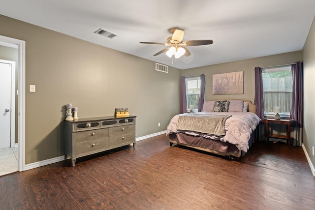 bedroom featuring baseboards, visible vents, and wood finished floors