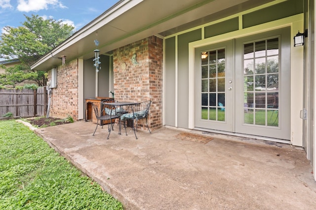 view of patio with french doors and fence