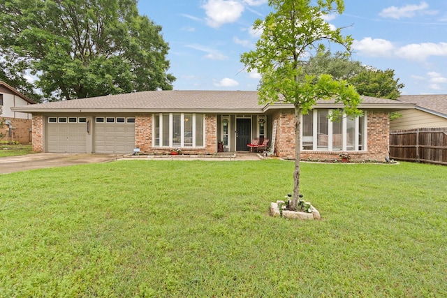 ranch-style house with driveway, a front yard, a garage, brick siding, and fence