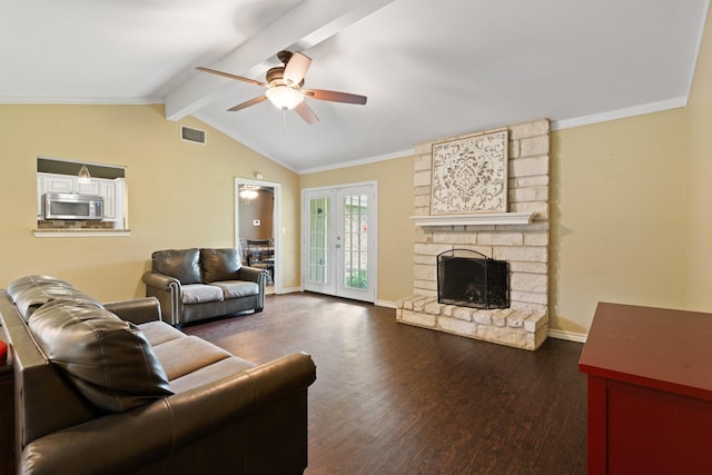 living area featuring visible vents, a ceiling fan, lofted ceiling with beams, and wood finished floors