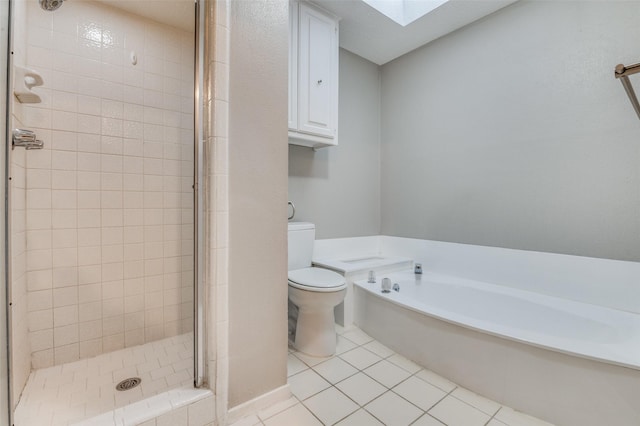 full bath featuring a shower stall, a skylight, tile patterned floors, toilet, and a garden tub