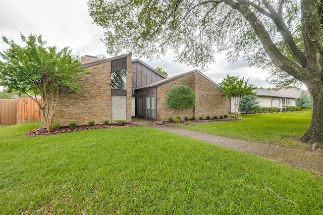 mid-century modern home featuring brick siding