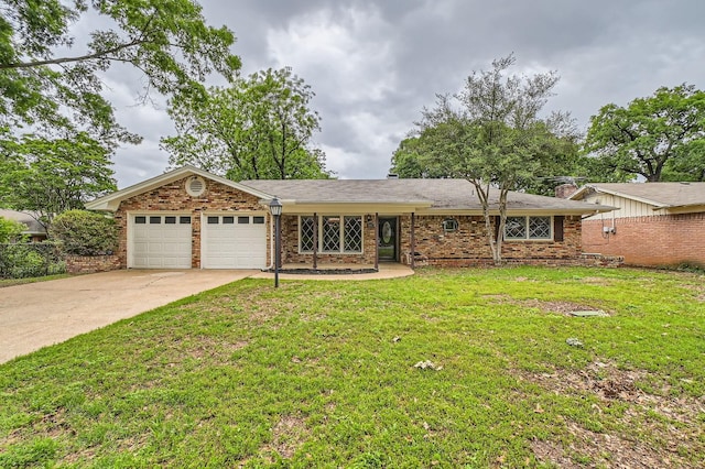 ranch-style home featuring brick siding, a garage, a front lawn, and driveway