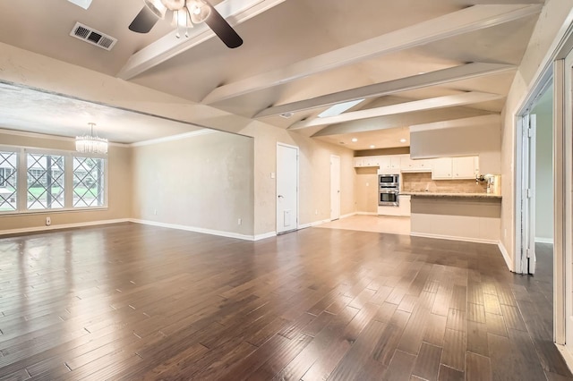 unfurnished living room with visible vents, baseboards, ceiling fan with notable chandelier, and dark wood-style floors