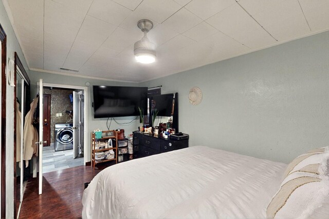 2241 Riviera Dr, Dallas, TX 75211 - bedroom with a closet, wood finished floors, and ornamental molding