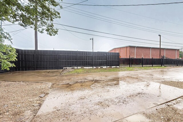 2241 Riviera Dr, Dallas, TX 75211 - back of property with fence and cooling unit