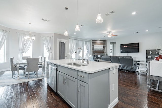 kitchen featuring stainless steel dishwasher, a sink, ceiling fan with notable chandelier, and visible vents