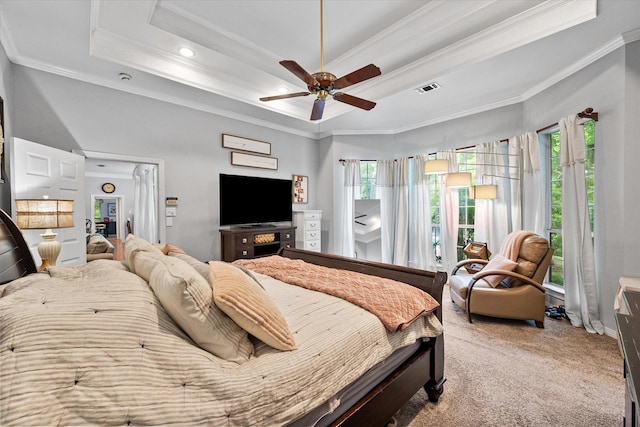 bedroom featuring crown molding, carpet flooring, visible vents, and a tray ceiling
