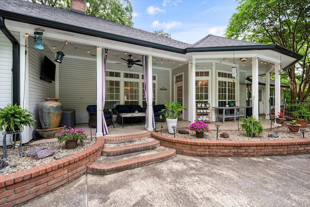 rear view of property with a patio, a ceiling fan, outdoor lounge area, and a chimney