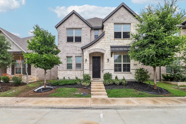 view of front of property featuring brick siding and stone siding
