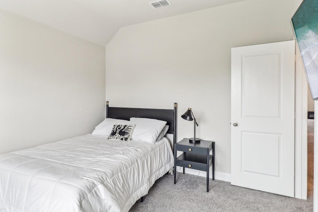 carpeted bedroom with vaulted ceiling and visible vents