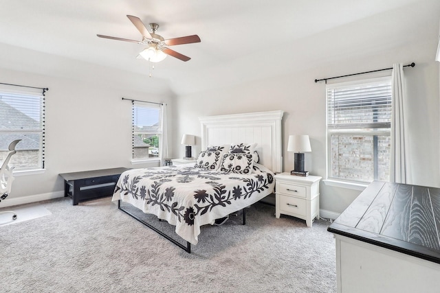 bedroom featuring a ceiling fan, baseboards, and light colored carpet