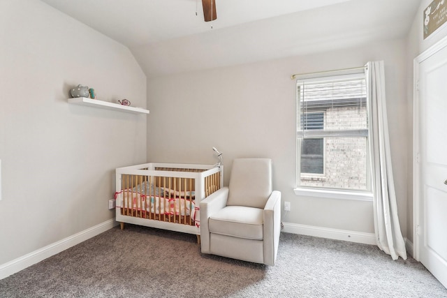 bedroom featuring carpet floors, baseboards, vaulted ceiling, and a nursery area